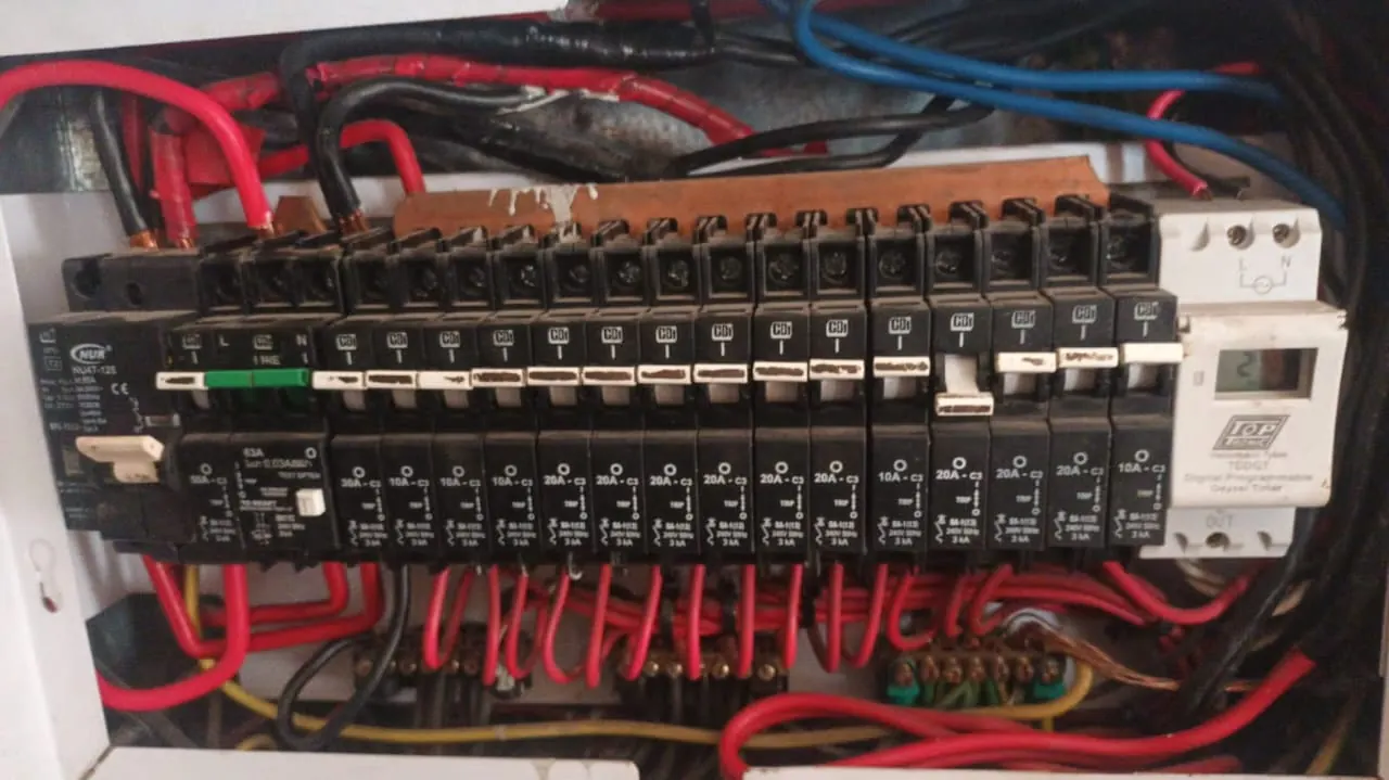 Open distribution board before rebuild, crowded unlabelled wiring