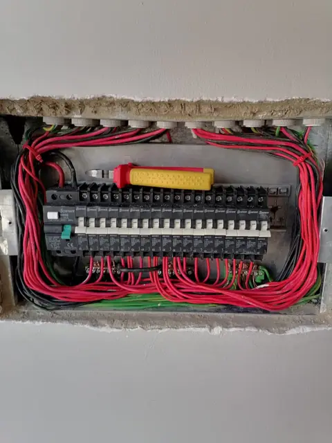 Open distribution board mid-rewire, conductors dressed and terminated