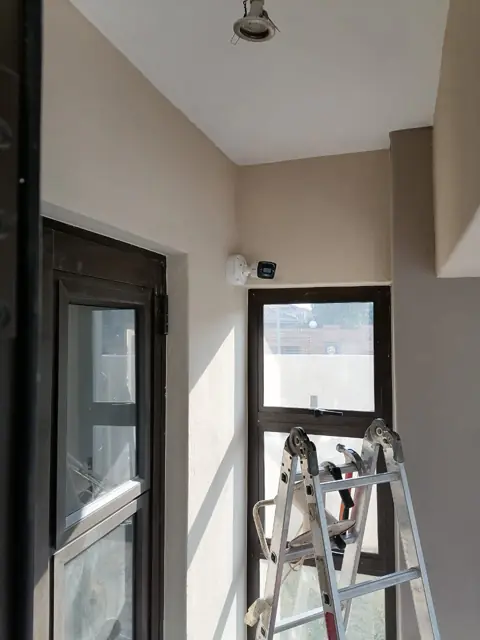 Room mid-renovation with a ladder, before the lighting went in